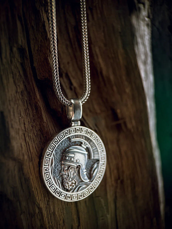 Silver pendant necklace on a wooden surface