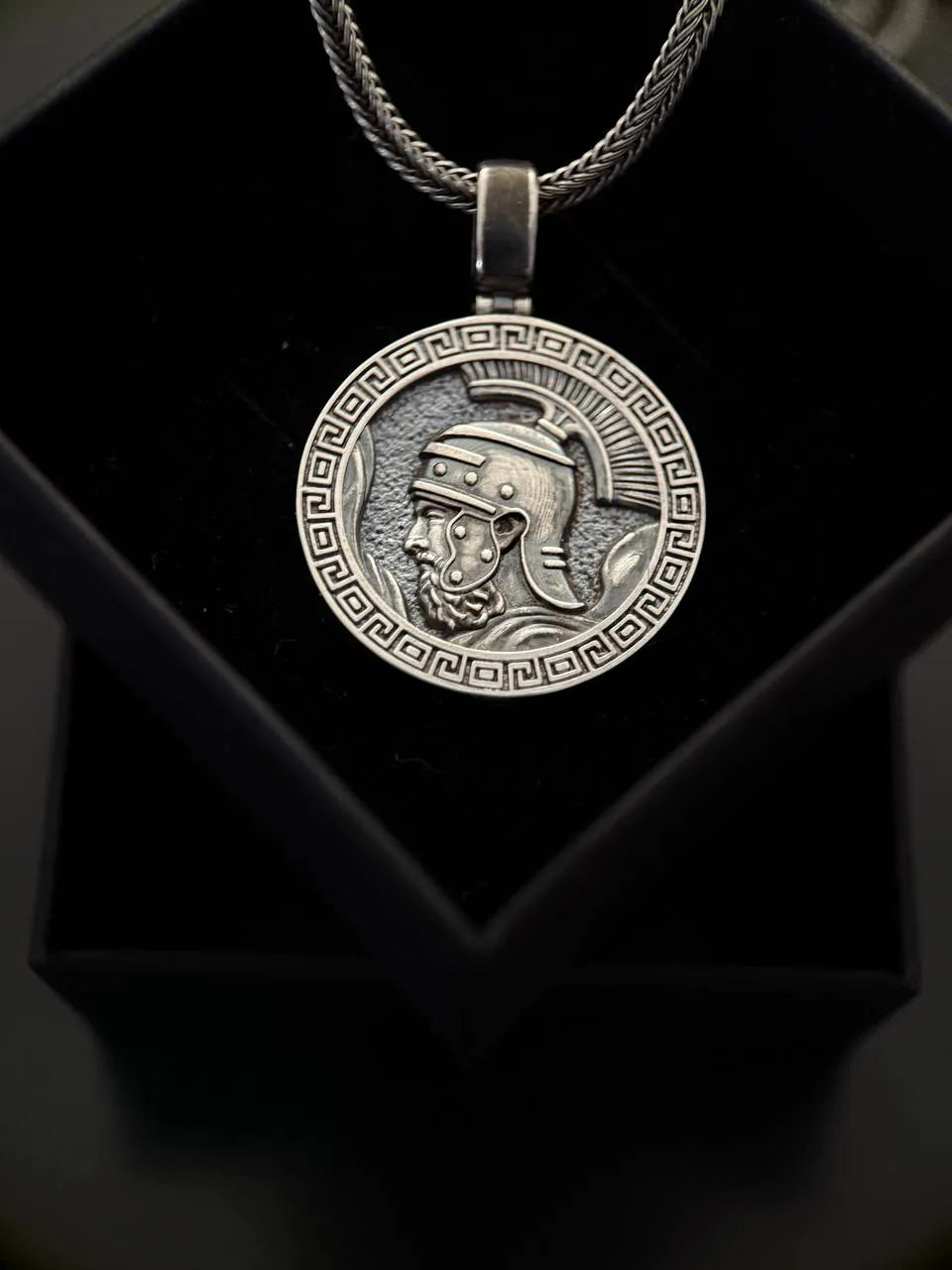 Silver pendant with  Marcus Aurelius warrior design on a black background
